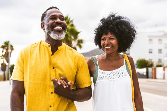 Couple walking while holding hands and smiling
