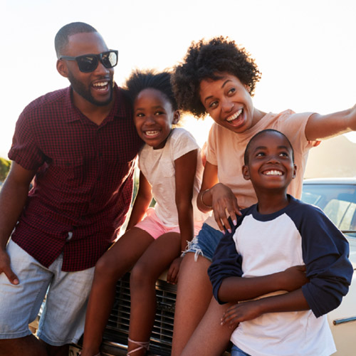 family of four taking a selfie on vacation